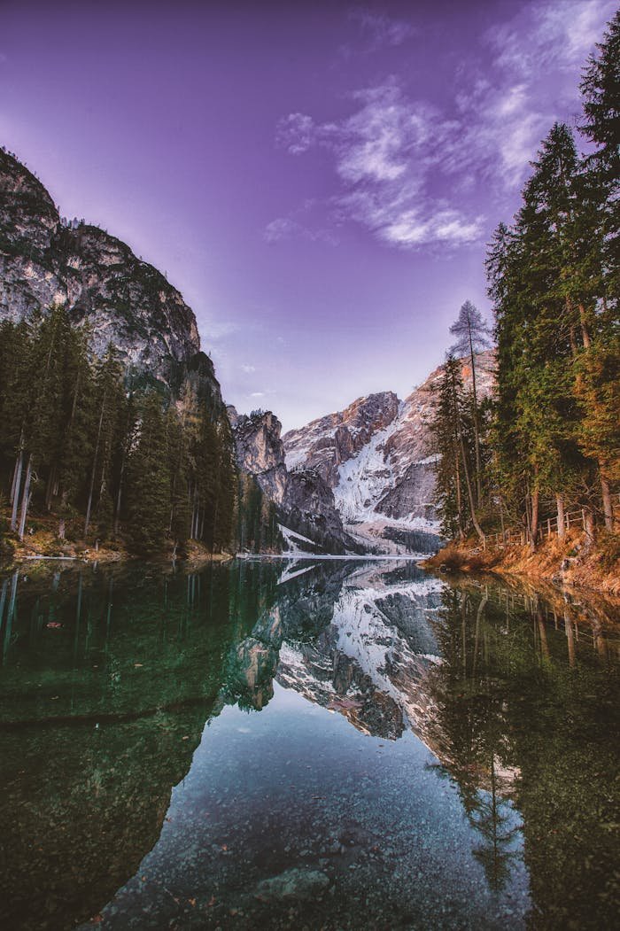 programs-03 Breathtaking mountain landscape with serene lake reflection during dawn, showcasing natures tranquility.