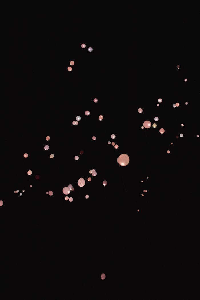 gallery-img-04 Aesthetic display of luminous spheres floating against a dark background, perfect for wallpapers.