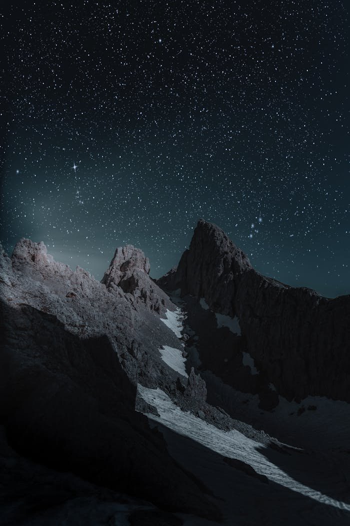 gallery-img-02 Breathtaking view of a rocky mountain peak under a starry night sky, perfect for wallpapers.